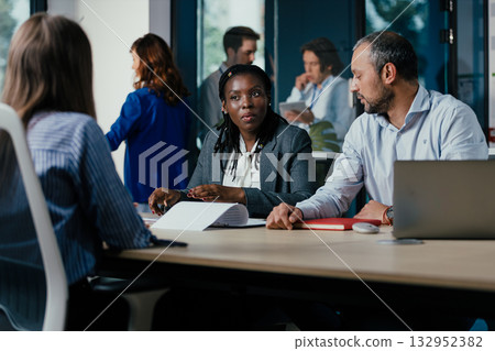 Diverse Business Team Meeting in Open-plan Modern Glass Office 132952382