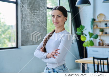 Portrait of confident successful teenage girl posing with crossed arms at home Portrait of confident successful teenage girl posing with crossed arms at home 132952412