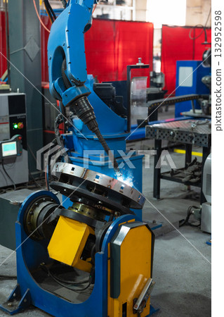 Automatic Industrial welding robot in a modern factory 132952598