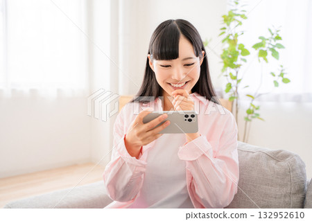Young woman watching video on smartphone 132952610