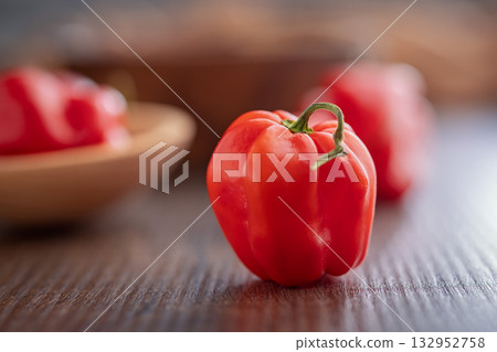 Red chili pepper habanero on wooden table. Red chili pepper habanero on wooden table. 132952758