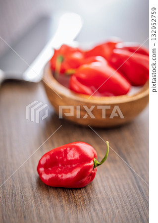 Red chili pepper habanero on wooden table. Red chili pepper habanero on wooden table. 132952759