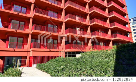 European residential architecture harmonizing with nature. Eco-friendly living in city with greens. Eco apartment building saving energy and fresh air concept.  132952954