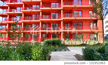 European residential architecture harmonizing with nature. Eco-friendly living in city with greens. Eco apartment building saving energy and fresh air concept.  132952963
