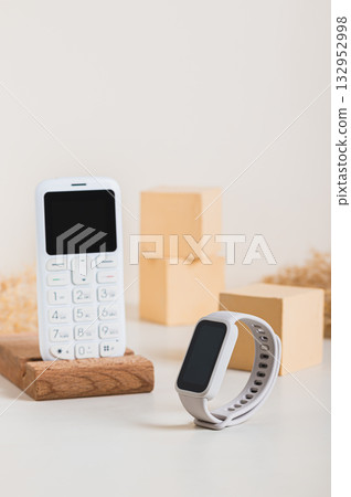 Synchronization of a retro push-button telephone and a fitness bracelet concept vertical view Synchronization of a retro push-button telephone and a fitness bracelet concept vertical view 132952998