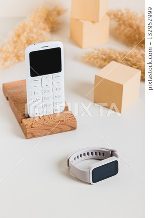 Wireless communication between a push-button telephone and a fitness bracelet vertical view 132952999