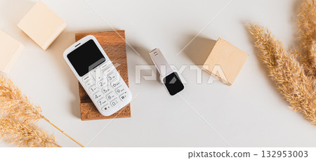 Wireless communication between a dump telephone and a fitness bracelet top view web banner Wireless communication between a dump telephone and a fitness bracelet top view web banner 132953003