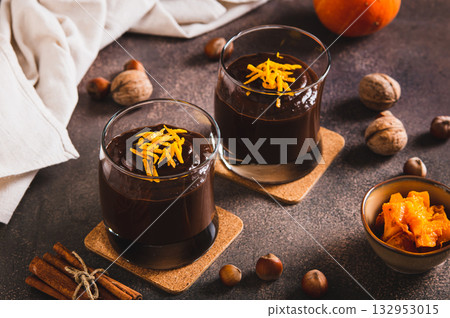 Autumn chocolate pumpkin dessert in glasses on the table Autumn chocolate pumpkin dessert in glasses on the table 132953015