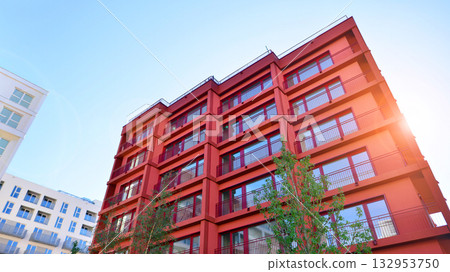 European residential architecture harmonizing with nature. Eco-friendly living in city with greens. Eco apartment building saving energy and fresh air concept. European residential architecture harmonizing with nature. Eco-friendly living in city with greens. Eco apartment building saving energy and fresh air concept. 132953750