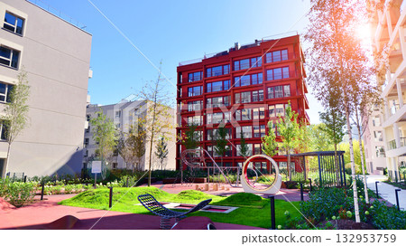 European residential architecture harmonizing with nature. Eco-friendly living in city with greens. Eco apartment building saving energy and fresh air concept.  132953759