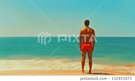 man in red swim trunks on sandy beach facing ocean 132953873