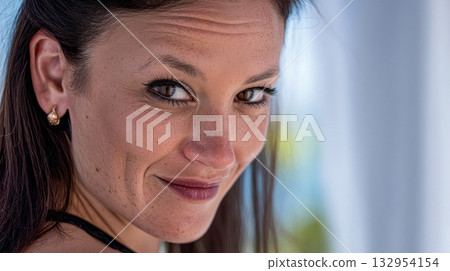 Woman smiling with confidence by the beach during sunny weather 132954154