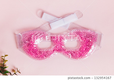 Close up of cooling cryo ice mask for face on pink background top view 132954167