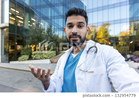 A doctor wearing a white coat and stethoscope communicates enthusiastically in a modern urban setting. 132954779