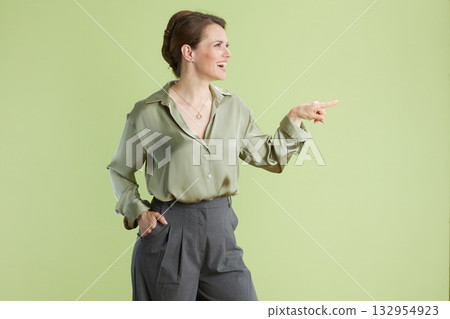 Confident presenter in green Confident presenter in green 132954923