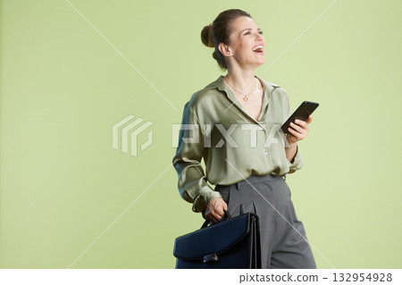 Joyful business: Woman with phone and briefcase 132954928