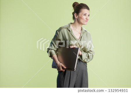 Woman with laptop, slight smirk Woman with laptop, slight smirk 132954931