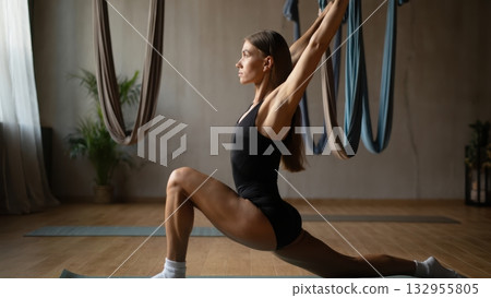 Young beauty woman doing yoga at home, for ad, meditation and healthy lifestyle. Flexible female athlete practicing Hanumanasana 132955805