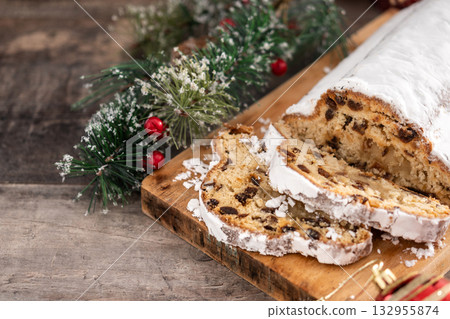 Traditional Christmas Stollen with Raisins on christmas background 132955874
