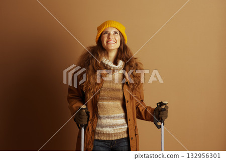 Smiling Hiker in Autumn Gear with Trekking Poles Smiling Hiker in Autumn Gear with Trekking Poles 132956301
