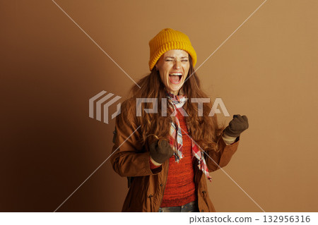 Exuberant Woman Celebrating with Fists Clenched Exuberant Woman Celebrating with Fists Clenched 132956316