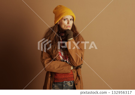 Pensive Woman in Autumn Gear, Hand on Chin Pensive Woman in Autumn Gear, Hand on Chin 132956317