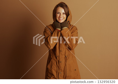 Warmly Smiling Woman in Hooded Parka 132956320