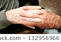 A man and an elderly man hold hands. The scene is warm, comforting, and reflects love and understanding. 132956966