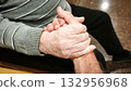 A man and an elderly man hold hands. The scene is warm, comforting, and reflects love and understanding. 132956968