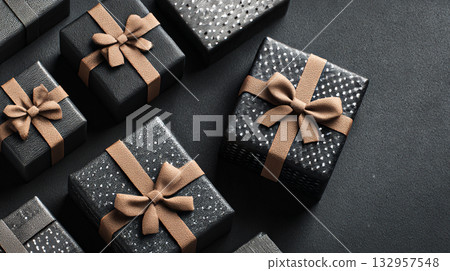Elegant Gift Boxes. A variety of stylish black gift boxes with brown bows on a dark surface. Elegant Gift Boxes. A variety of stylish black gift boxes with brown bows on a dark surface. 132957548