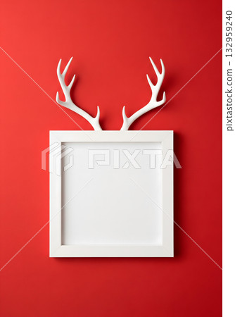 White antlers peeking over a white frame against a vibrant red background 132959240