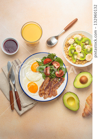 Breakfast warm beige background eggs vegetables salad, oats fruit, croissants, coffee, juice healthy morning. Breakfast warm beige background eggs vegetables salad, oats fruit, croissants, coffee, juice healthy morning. 132960132