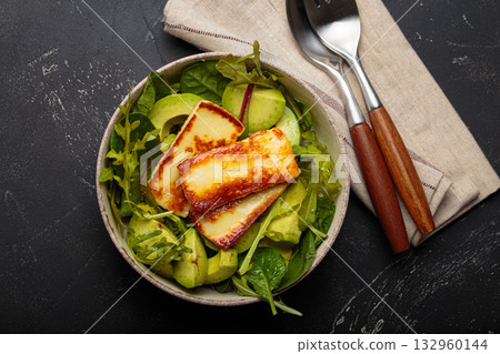 Halloumi avocado salad greens bowl healthy vegetarian diet nutrition top view Halloumi avocado salad greens bowl healthy vegetarian diet nutrition top view 132960144