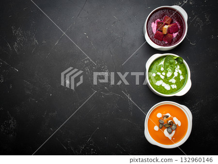 Three bowls colourful vegetable soups black background healthy diet cooking detox copy space Three bowls colourful vegetable soups black background healthy diet cooking detox copy space 132960146