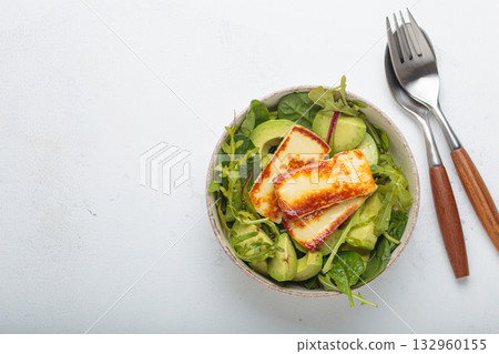 Halloumi avocado salad greens bowl healthy vegetarian diet nutrition top view copy space Halloumi avocado salad greens bowl healthy vegetarian diet nutrition top view copy space 132960155