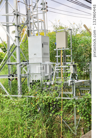 The equipment Control cabinet used with 5G telephony tower system Installed in rural areas. The equipment Control cabinet used with 5G telephony tower system Installed in rural areas. 132960448