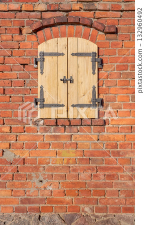 Old brick wall with new wooden shutters. Old brick wall with new wooden shutters. 132960492