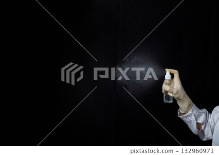 Spraying a fine mist of liquid. 132960971