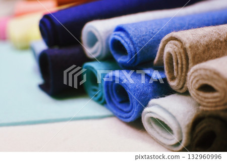 Close-up of piles of cool-colored felt fabric. Crafts, sewing, fabric, handmade. 132960996