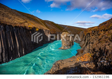 Studlagil Canyon in Iceland features striking basalt columns and a vibrant turquoise river. This natural landscape is ideal for hiking and photography, showcasing Iceland's unique geology. Studlagil Canyon in Iceland features striking basalt columns and a vibrant turquoise river. This natural landscape is ideal for hiking and photography, showcasing Iceland's unique geology. 132961196