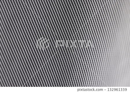 fabric for white tulle or curtains close up, finely woven synthetic threads for making tulle for windows in the home 132961339