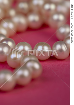 shaped pearls from a marine mollusk used in the manufacture of women's jewelry beads, a necklace made from natural pearl beads strung on a string 132961384