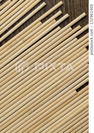 Thin round bamboo sticks are used as supports for indoor or other plants or for cooking, thin long sticks made of bamboo have a wide range of applications from cooking Thin round bamboo sticks are used as supports for indoor or other plants or for cooking, thin long sticks made of bamboo have a wide range of applications from cooking 132961409