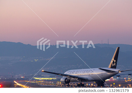 日落時分，一架飛機在跑道上掉頭。 132961579