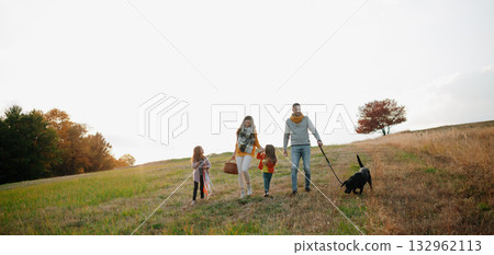 Happy young family with two children in autumn nature at sunset. Happy young family with two children in autumn nature at sunset. 132962113