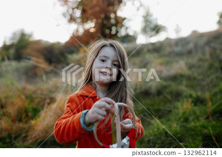 Portrait of beautiful young girl on walk in autumn nature, spending sunday outdoors. 132962114