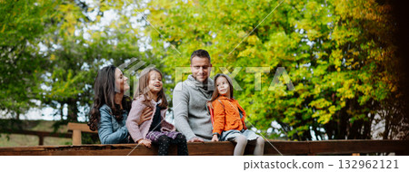 Family enjoing beautiful view during walk, warm autumn day. Family enjoing beautiful view during walk, warm autumn day. 132962121
