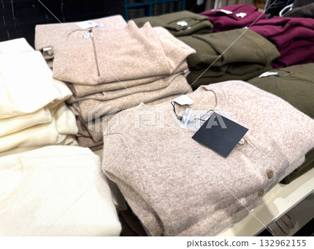 Folded cashmere and wool sweaters on shelf Folded cashmere and wool sweaters on shelf 132962155