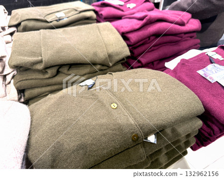 Stacked cozy knitwear neatly arranged in boutique Stacked cozy knitwear neatly arranged in boutique 132962156
