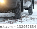 Car wheel with winter tire on the gravel road at winter time Car wheel with winter tire on the gravel road at winter time 132962834